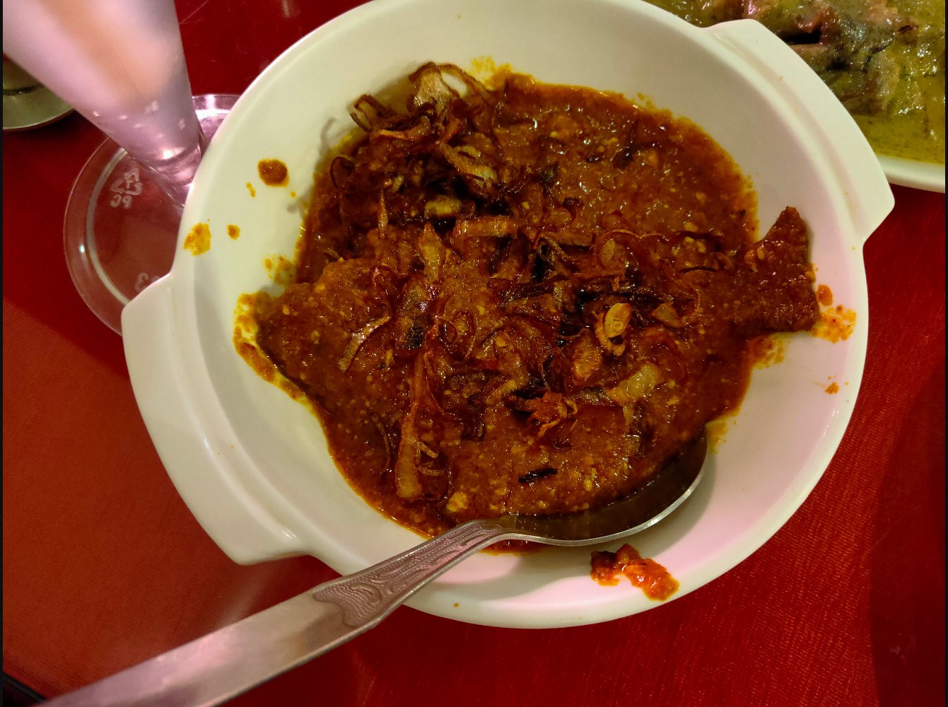 Rich Bengali curry topped with fried onions