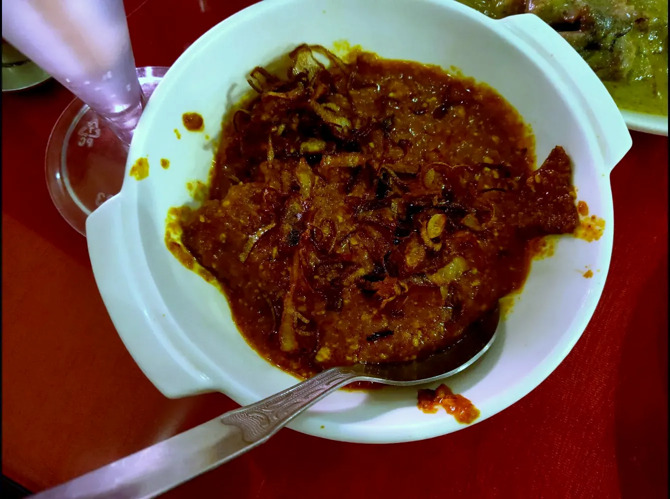 Rich Bengali curry topped with fried onions