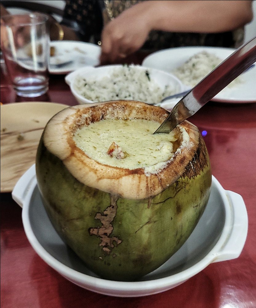 Daab chingri served in a green coconut