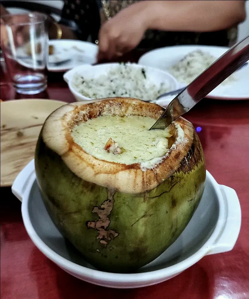Daab chingri served in a green coconut