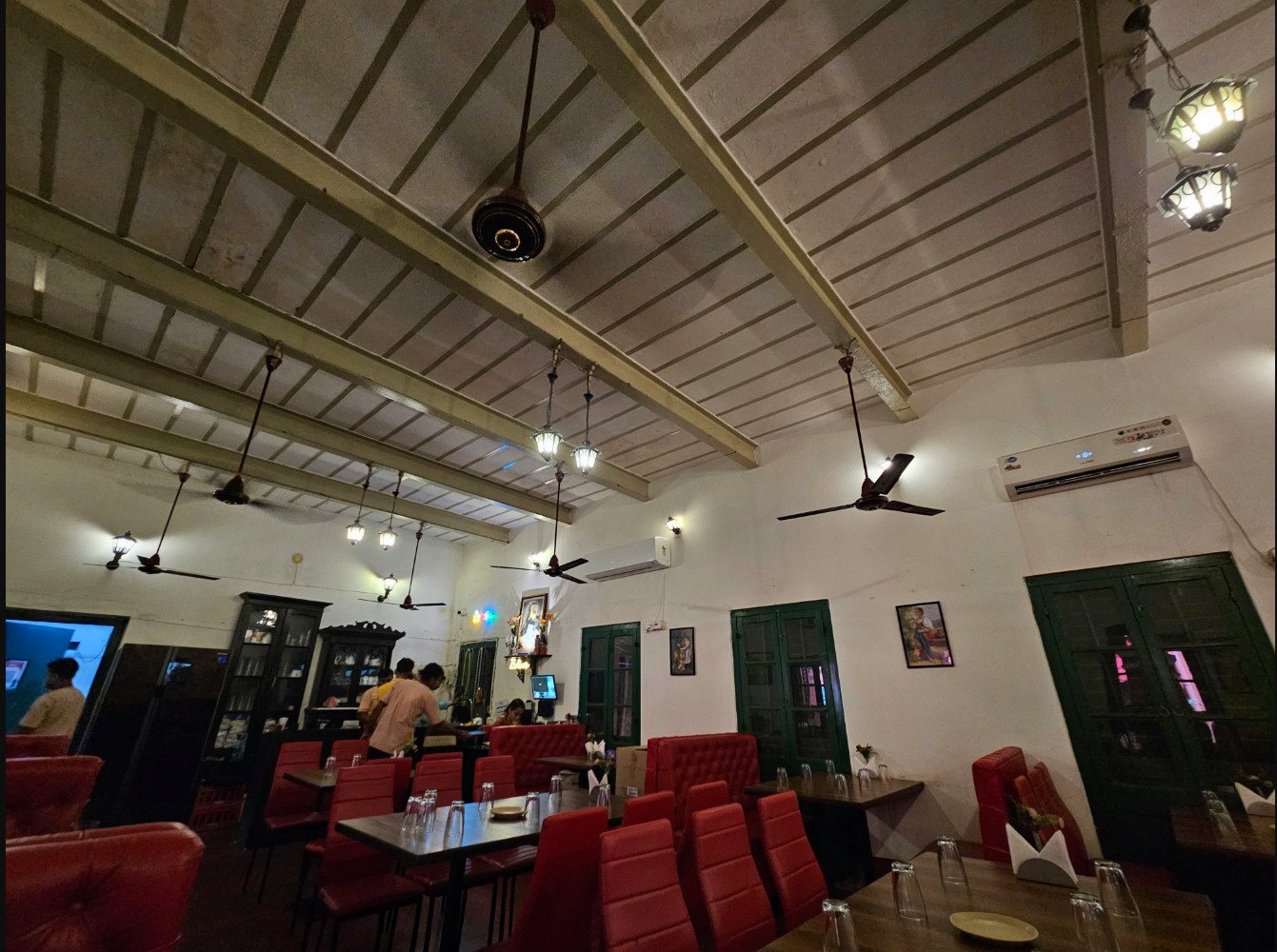 Vheto dining hall with red chairs and beamed ceiling